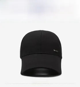 Front view detail of a black baseball cap with a rectangular metal logo plate