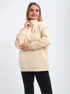 Detail of half-zip stand collar and silver metal zipper on beige fleece sweatshirt