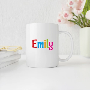 Custom white ceramic mug with colorful Emily name print in a cozy home office setting