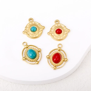 Detailed view of 18K gold plated sun and oval pendants with natural blue and red stones