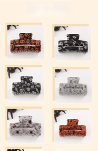 Set of six Halloween hair claws featuring pumpkin ghost and spider motifs in a 2x3 grid