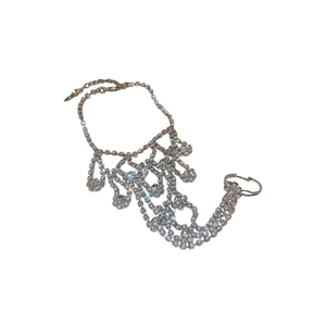 Elegant silver ring bracelet hand chain with sparkling rhinestones on white background