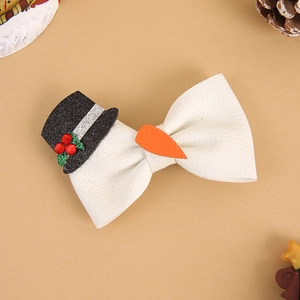Close-up of a Christmas snowman bow hair clip with leather texture and sequins