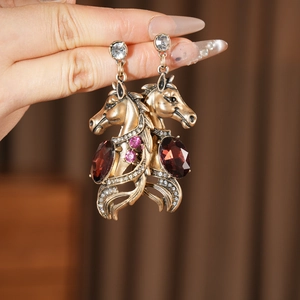Détails des boucles d'oreilles vintage tête de cheval avec pierres rouges et strass