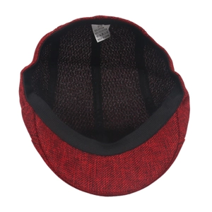 Detailed top view of red and black woven flat cap showing sweatband and care label