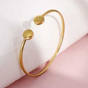 Golden open cuff bracelet with Hope engraving and Tree of Life symbol in stainless steel