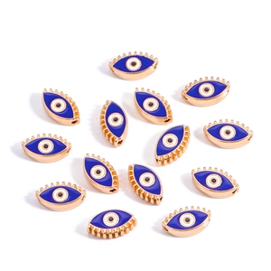 Macro shot of 10mm gold evil eye alloy beads with blue enamel inlay for DIY jewelry