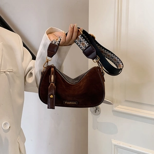 Brown suede half-moon shoulder bag with geometric wide strap and fashion metal plate