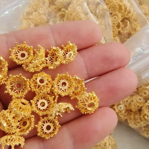 Macro shot of gold hollowed flower bead caps for DIY jewelry making and handcrafting