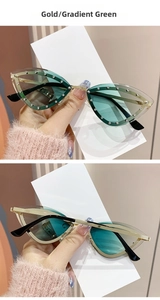 Détail de lunettes œil de chat avec verres dégradés verts et bordure en strass