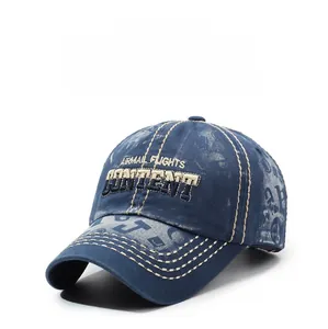 Detailed macro of vintage washed denim baseball cap with beige stitching and 3D embroidery