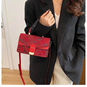 Vue détaillée d'un sac à main rouge avec broderie papillon 3D et fermoir doré chic