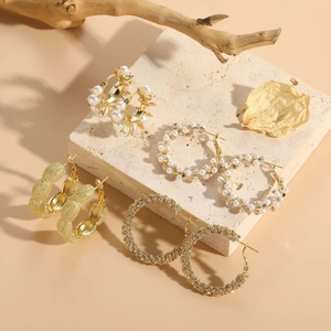 Detailed set of 14K gold plated earrings featuring pearls and zircons in geometric designs