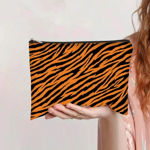 Detail view of the durable leopard print canvas bag with orange tiger pattern and zipper