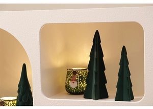 Detail of flocked ceramic Christmas trees and glowing gnome candle jar decor