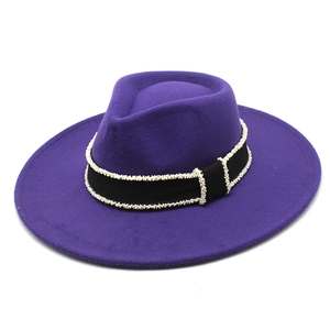 Detail of dark purple wool fedora hat featuring black ribbon band with white pearl accents