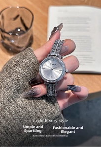 Close-up of elegant silver women watch with sunray dial and shimmering rhinestone bezel