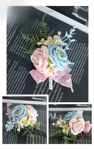 Detail of pink and blue artificial wedding boutonniere with silk ribbons and green leaves