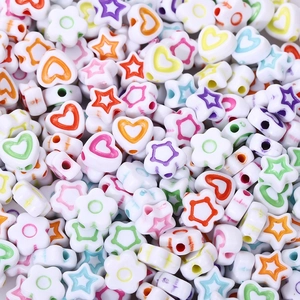 Macro shot of colorful heart star and flower shaped acrylic beads for DIY jewelry making
