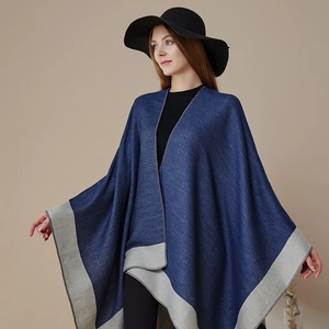 Elegant navy blue knitted poncho wrap with grey trim and matching brimmed hat stylish outfit