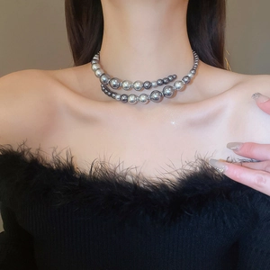 Double-layer grey pearl necklace on model with gradient tones and metal accents