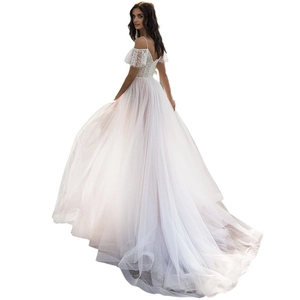 Elegant white lace wedding dress with spaghetti straps and a tiered tulle floor-length skirt