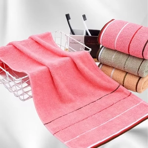 Detailed texture of colorful cotton towels with ribbed edges in a metal storage basket