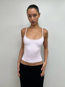 Close-up of pink slim fit U-neck tank top with delicate knit texture and thin straps