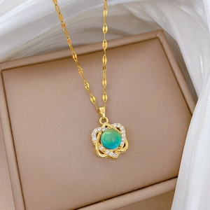 Elegant gold titanium necklace with a round teal gemstone pendant and sparkling zircons