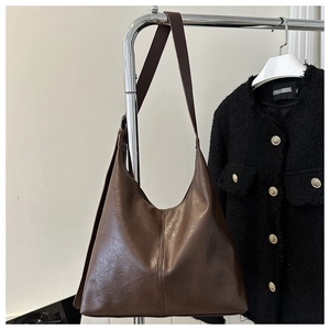 Detail of dark brown PU leather hobo bag showing soft texture and shoulder strap