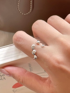 Close-up of modern irregular liquid metal wavy open ring in 925 sterling silver