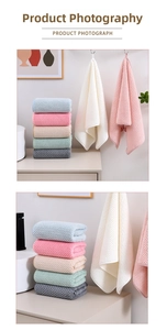 Detailed view of waffle textured coral fleece towels in multiple soft pastel colors