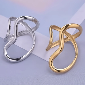 Detailed view of silver and gold curved irregular wave rings on a purple background