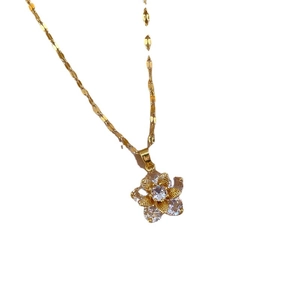 Titanium steel gold necklace featuring a snowflake zircon pendant on a white background
