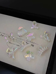 Close-up of colorful iridescent mini hair clips in various star heart butterfly shapes