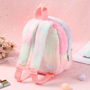 Detailed view of rainbow plush unicorn backpack with soft faux fur and pink straps