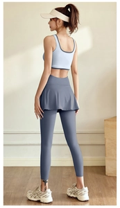 Rear view of high-stretch sports bra and blue-grey layered fitness leggings set
