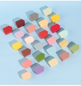 Macro shot of colorful non-latex triangle makeup sponges neatly arranged on blue background