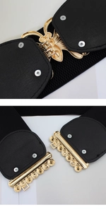 Close-up of golden butterfly buckle and inner mechanism on black elastic corset belt