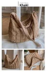 Close-up of khaki quilted puffer tote bag with spacious interior and wide shoulder strap