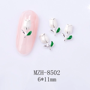 Close-up of 6x11mm white tulip nail charms with green leaves for DIY manicure