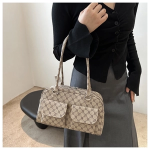 Detail of vintage monogram underarm bag featuring dual front flap pockets and leather strap