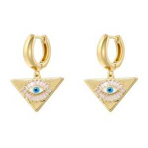 Detail of gold triangle drop earrings featuring evil eye charms and cubic zirconia