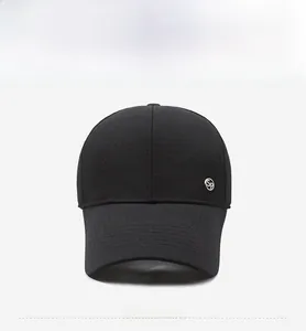 Detail of black baseball cap featuring a round silver metal SP logo on the front panel
