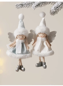 Close-up of plush angel ornaments with knit dresses on snowy pine branches for Christmas