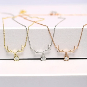 Detailed view of reindeer antler necklaces in gold silver and rose gold with zircon stones