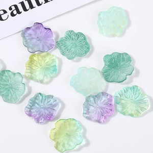 Macro detail of gradient flower-shaped glass beads for DIY jewelry making and crafts