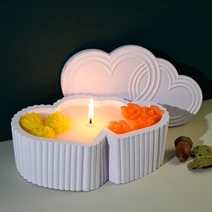 Detail of a double heart shaped candle box with striped texture and wax flowers