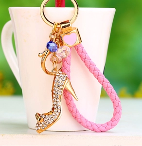 Close-up of pink crystal high heel keychain with gold-tone lobster clasp and woven cord