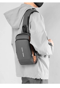 Detail of water-resistant gray chest bag with USB charging port and FASHION text